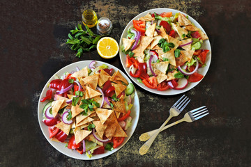 Middle Eastern salad "Fattoush" with vegetables and pita. Bright healthy vegan salad. Middle Eastern cuisine.