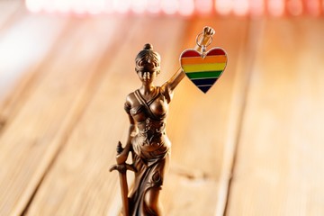 Statue of Temide - symbol of law and justice holding heart with lgbt colours
