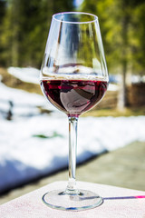 A glass of red Cabernet wine in a lodge in Cortina d'Ampezzo, Dolomites, Italy