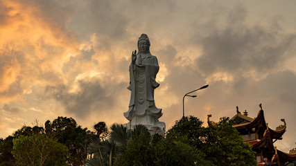 Fototapeta premium Ho quoc pagoda in phu Quoc island. Monument of Lady buddha in a beautiful sunset in Vietnam