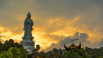 Fototapeta premium Ho quoc pagoda in phu Quoc island. Monument of Lady buddha in a beautiful sunset in Vietnam