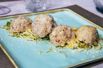 Detail of a plate of Canederli, a typical italian pasta made with bread, Cortina D'Ampezzo, Italy