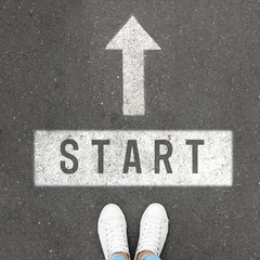 Woman standing near arrow on asphalt, top view. Choice concept
