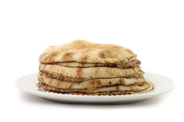 Pita bread isolated on white background in ceramic dish. Traditional food of Arabic cuisine