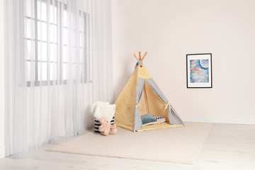 Cozy child room interior with play tent near window