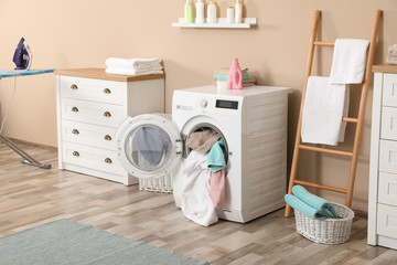 Bathroom interior with dirty towels in washing machine