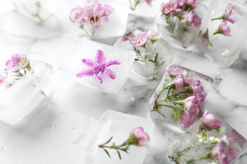 Floral ice cubes on marble table