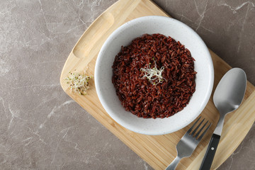 Boiled brown rice served on table, top view. Space for text