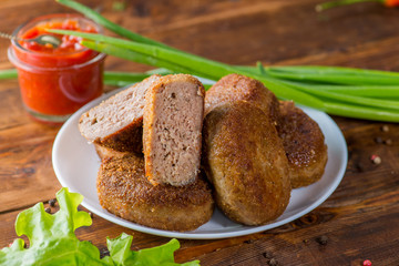 cutlet cut in half on the background whole on a plate