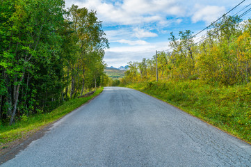Fototapeta na wymiar Empty road on Hakoya - a 3.69-square-kilometre island located between the islands Kvaloya and Tromsoya in Troms county, Norway