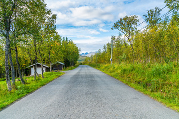 Fototapeta na wymiar Empty road on Hakoya - a 3.69-square-kilometre island located between the islands Kvaloya and Tromsoya in Troms county, Norway