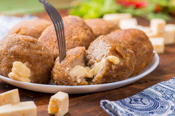 slice of cut cutlet stuffed with cheese. Hot melted cheese inside cutlet