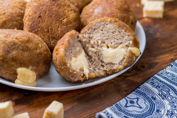 slice of cut cutlet stuffed with cheese. Hot melted cheese inside cutlet