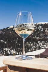 A glass of white sparkling Prosecco wine in a lodge in Cortina d'Ampezzo, Dolomites, Italy
