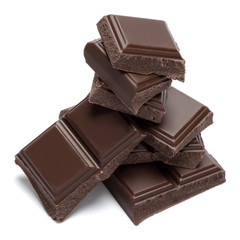 Dark organic chocolate pieces isolated on white background