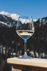 A glass of white sparkling Prosecco wine in a lodge in Cortina d'Ampezzo, Dolomites, Italy
