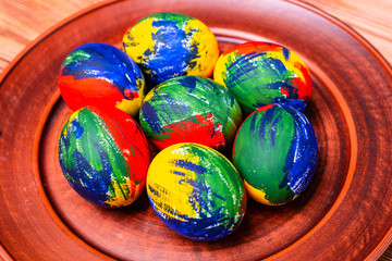 Easter multi-colored eggs, paints and brush on a table. Preparation for a holiday