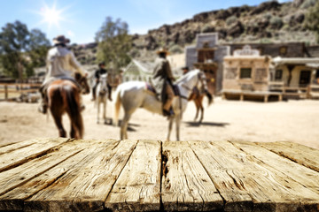 Wooden table of free space for your decoration and wild west background 