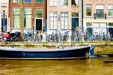 Fototapeta na wymiar Bicycles parked on street in Amsterdam in rainy day, The Netherlands