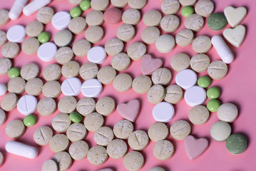 harmaceuticals antibiotics pills medicine /colorful antibacterials pills on pink background /capsule pill medicine. Creative idea. Drugs. Sad. Die. Illness