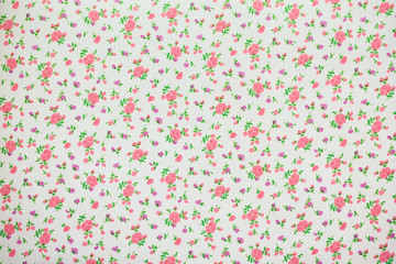 A piece of fabric with the image of small flowers in pastel colors