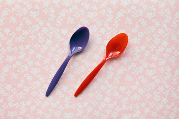 two plastic spoons for children on a fabric background