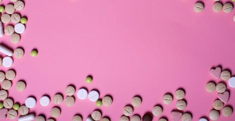 Fototapeta na wymiar harmaceuticals antibiotics pills medicine /colorful antibacterials pills on pink background /capsule pill medicine. Creative idea. Drugs. Sad. Die. Illness