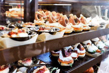 Tapas on Crusty Bread - Selection of Spanish tapas served on a sliced baguette.