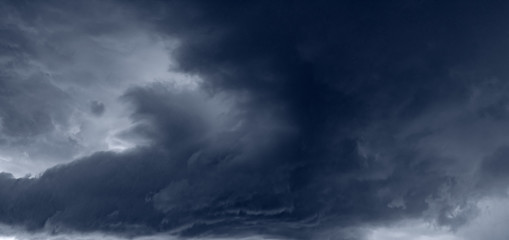 Panorama of the sky during a thunderstorm. Dark dramatic stormy sky.