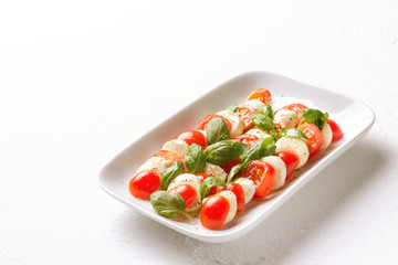 Caprese Salad. Tomatoes, basil, mozzarella and oil.