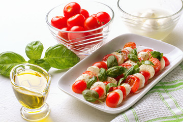 Caprese Salad. Tomatoes, basil, mozzarella and oil.