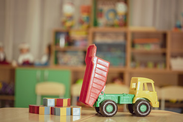 children's toy car dump truck in kindergarten playroom