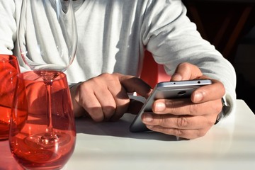 Male hands using a mobile in the lunch break
