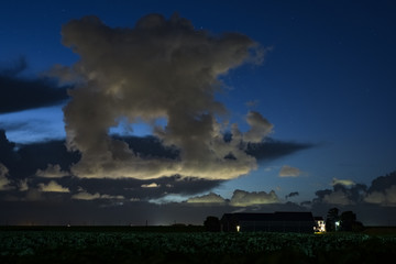 Fototapeta na wymiar Strange cloud forms over the dutch countryside in the evening