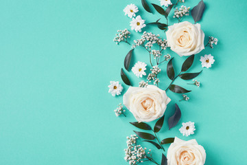 Beautiful white flowers composition on blue background