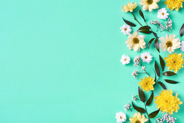Beautiful yellow and white flowers composition on blue background
