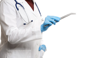 Photo of side of doctor in white coat in rubber gloves, holding tweezers