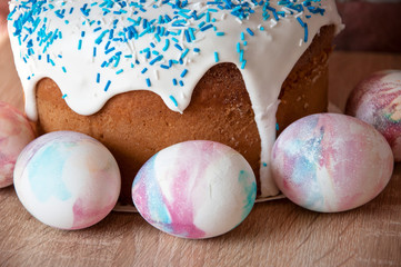 Spring holiday prepare. Marble shell. Happy easter. Dessert. Backery. Easter cake with sprinkles on glaze. Painted eggs. Easter cake on table. Egg hunt. Traditional food cooking. Easter preparations