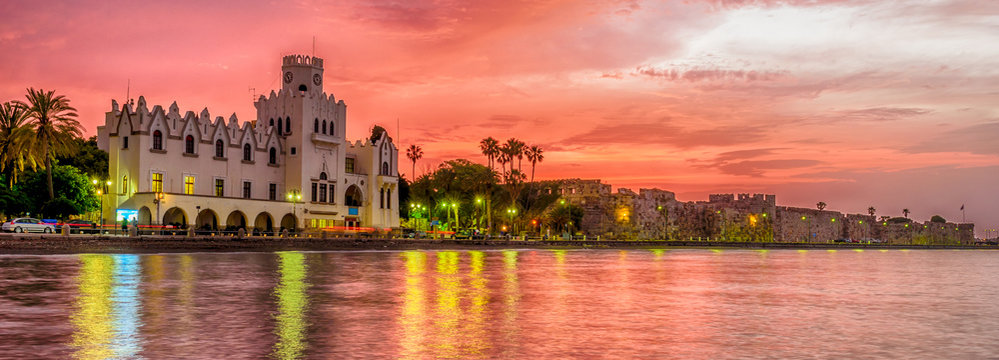 Wonderful Greece. Attractions of the island of Kos. Kos fortress and the municipal building at sunset, Kos town, Kos island, Dodecanese, Greece