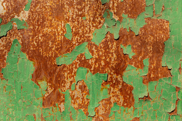 Corrosion of metal. Peeling green paint from the iron surface.
