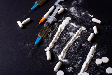 Hard drugs on dark table. heroin, cocaine, amphetamine, ecstasy, pills and more. Creative idea....