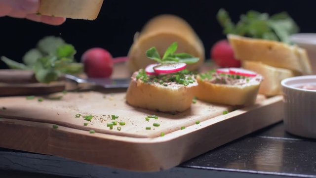 Taking a sandwich with a pate from the wooden board