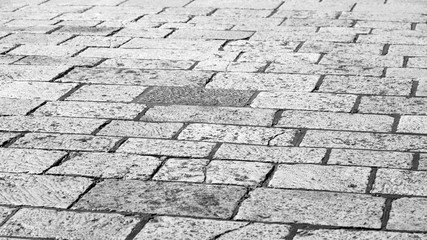 Abstract background of old cobblestone pavement close-up.