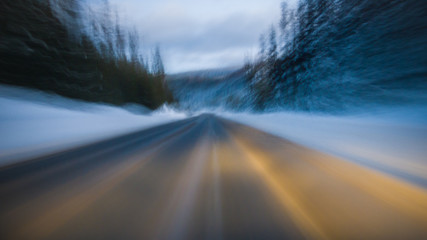 Picturesque view of countryside route and hills with trees in winter in Canada