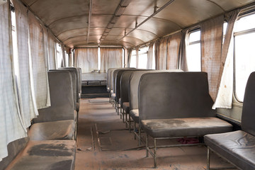 Vintage deserted bus with seats in dust