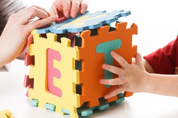 Child playing with puzzle blocks abc alphabet,  colorful.