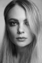 Black and white portrait of young beautiful woman with smoky eye make-up