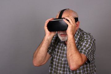 Man wearing virtual reality goggles. Studio shot.