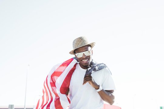 Cheerful black man with American flag