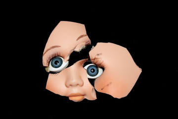 Broken Doll Head Face On Black Background